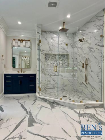 master bathroom by BEN's Remodeling with stand up shower, white marble tiles, gold finishing