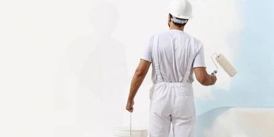 a craftsman painting a wall