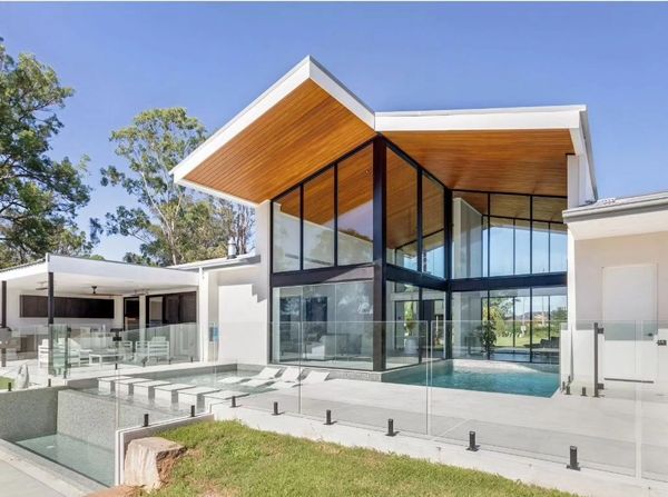Pool, Timber ceiling, waterfall, pool chairs, windows, blue sky