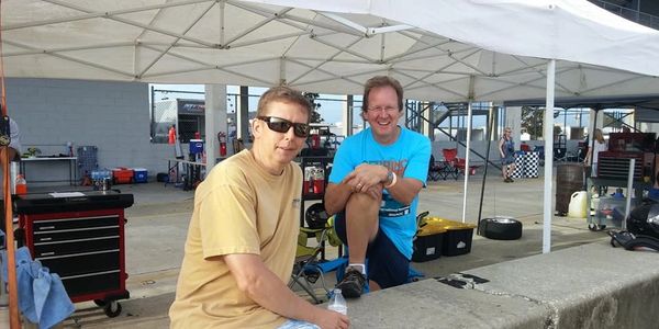 Customers, Bob Varga and Don Chrzan, (left to right) hang out in the pit after an event.