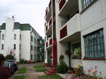 A apartment building with 1930 steel, crittall windows in green with small panes