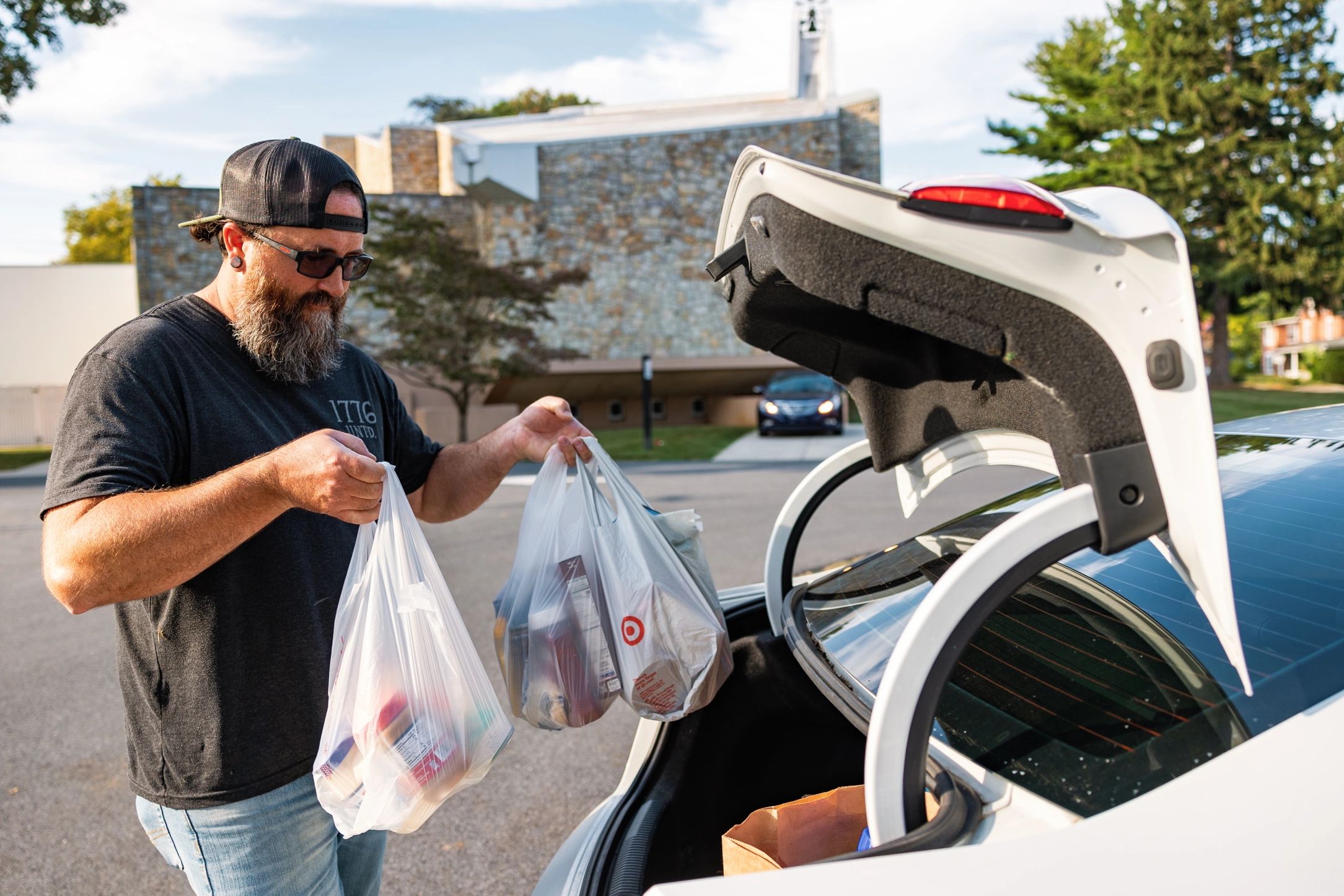 Volunteer filling his trunk with groceries