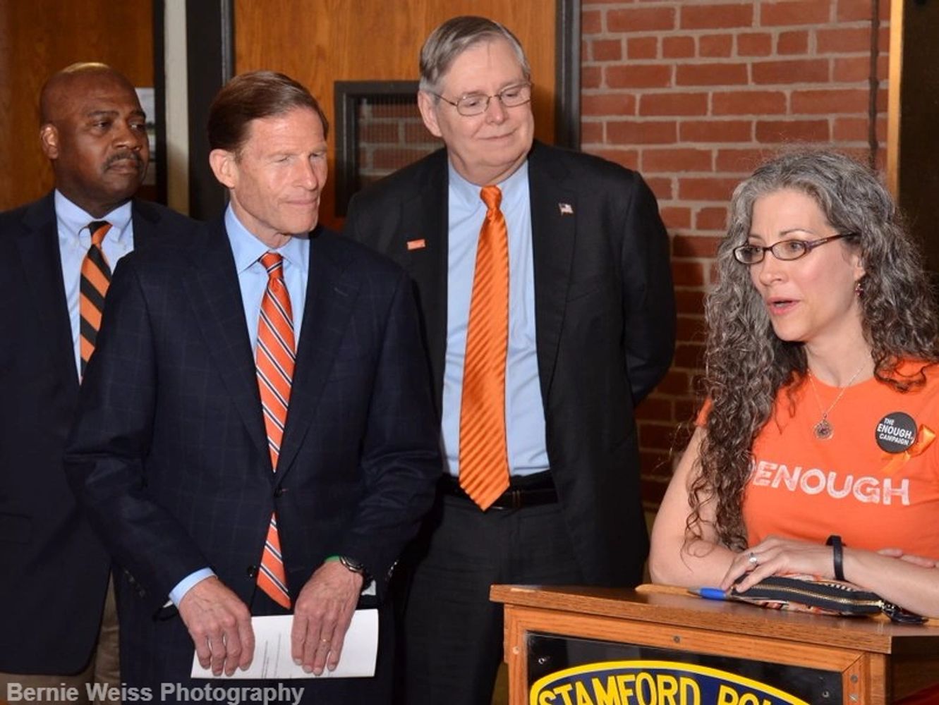 Shira Tarantino speaks as Stamford Mayor Martin, CT Sen. Richard Blumenthal, Michael Hyman look on.