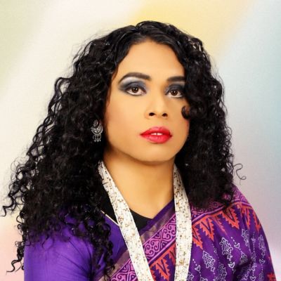 Woman with curly hair in colorful traditional attire.