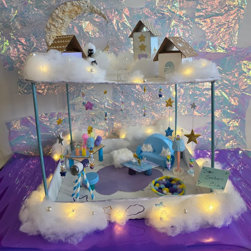A dreamy craft diorama with fairy lights and stars.