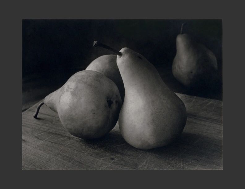 Three pears on a cutting board.