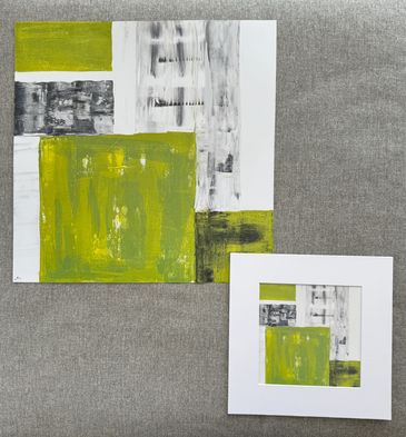 Two prints of the same art; imperfect squares and rectangles of messy green, white and grey colors.