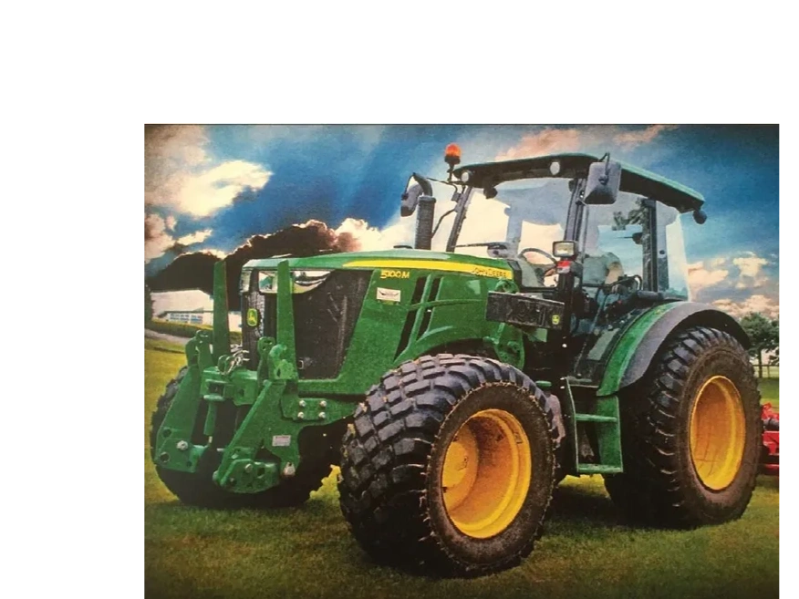 Green John Deere 5100M tractor on grass under a cloudy sky.