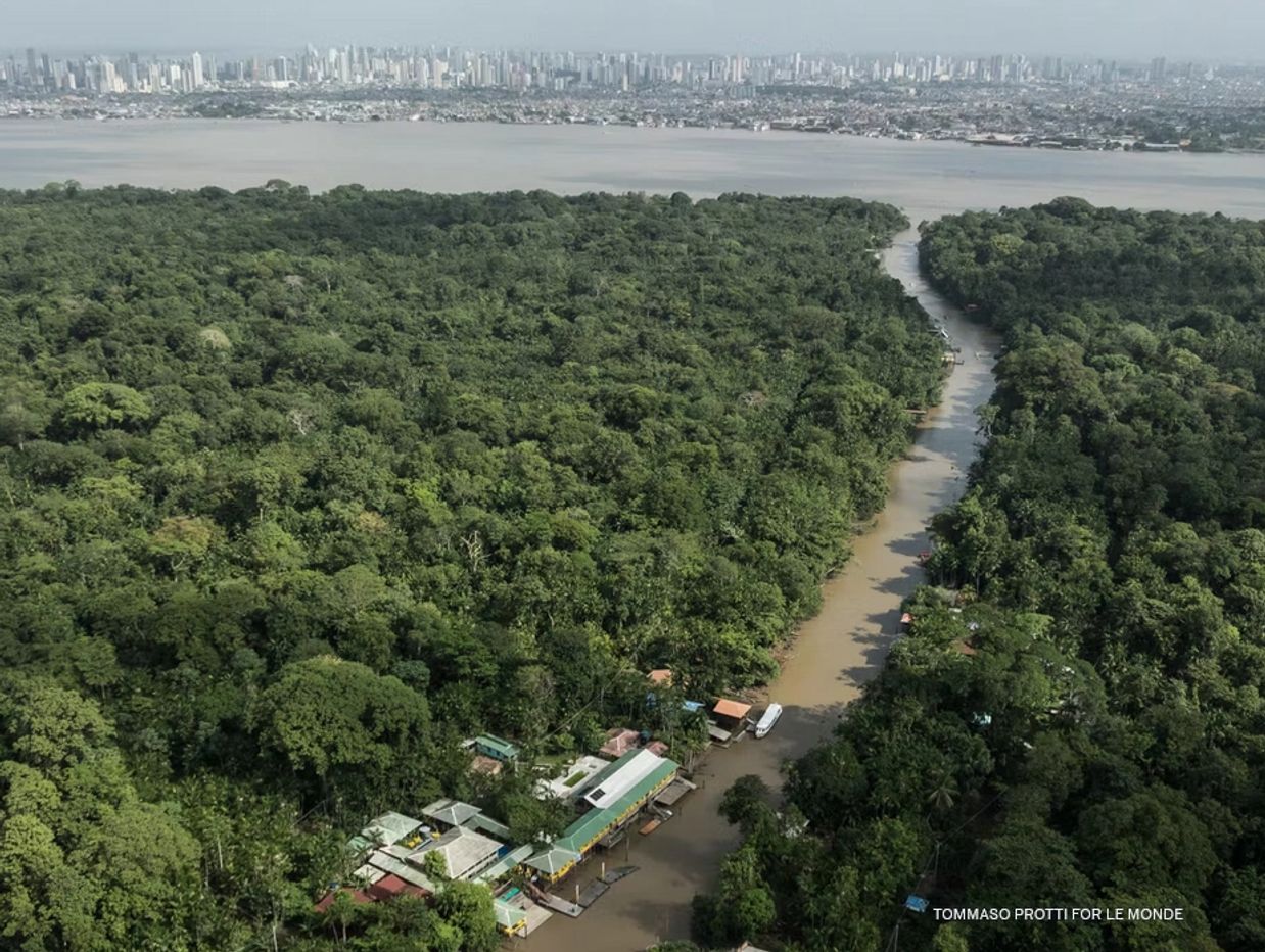 Belem , Brazil, site of COP 30, a city of rivers, towered by human settlements in the background.