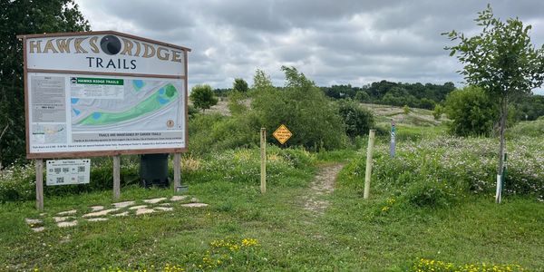 Trailhead entrance to Hawks Ridge Trails on a cloudy day.