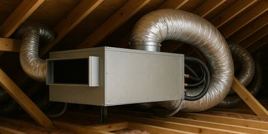 HVAC system installed in an attic with wooden beams and insulation.