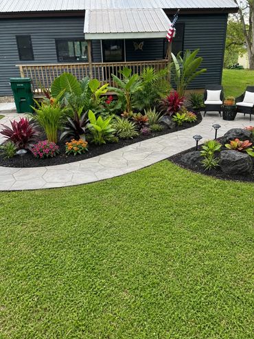 A landscaped garden path with lush plants and flowers.