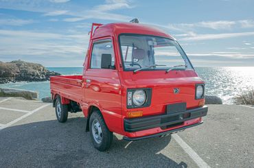 1988 Subaru Sambar Kei Truck in red, sold by OIWA, perfect for coastal work and leisure.
