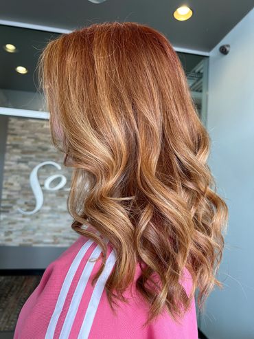A natural copper shade styled in loose beach waves. Bright copper highlights and lowlights.