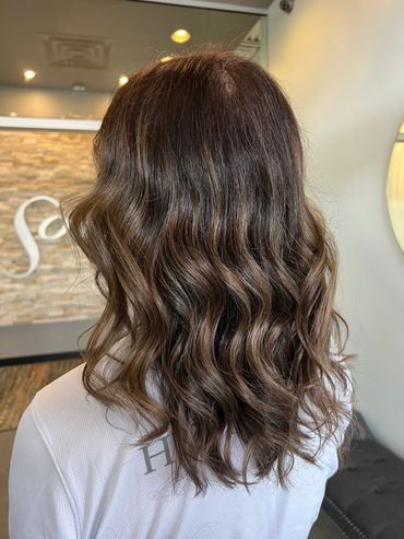 This is a dimensional brunette balayage highlight & lowlight. Low maintenance color with beach waves