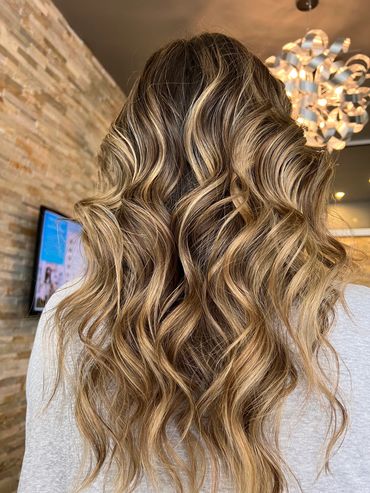 Brunette and blonde balayage highlight with beach waves. It's a lived in color & is low maintenance