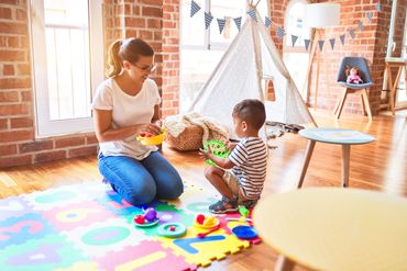 Mother has a studio with matts an arts and crafts. The child is busy trying to assemble them