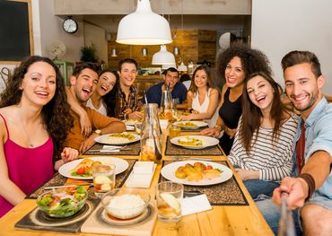 Large group of friends having a meal at a restaurant