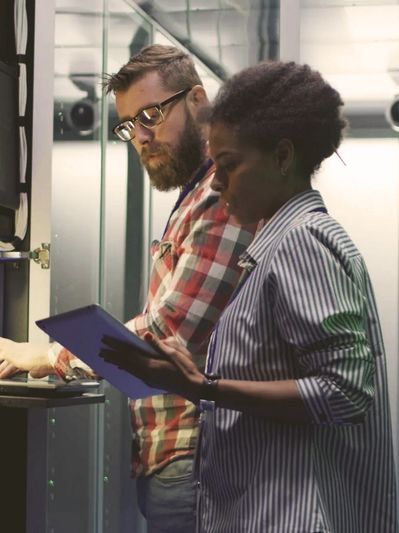 Woman and man working in a datacenter