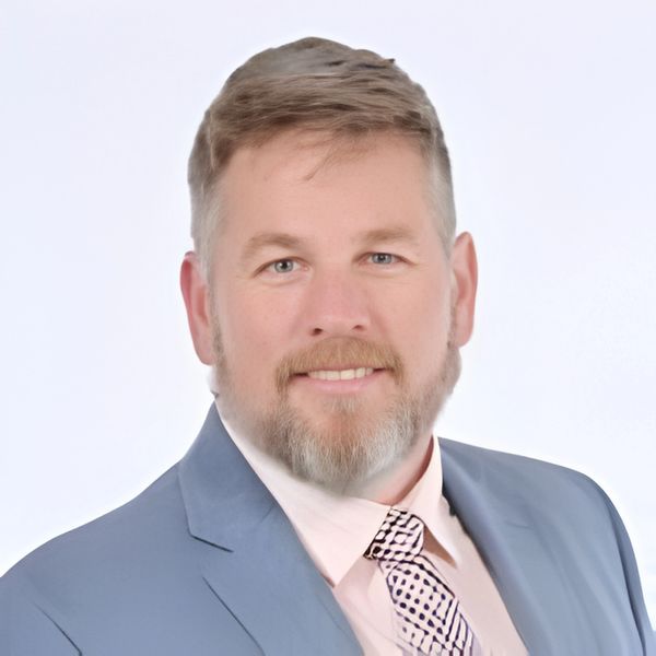 Professional man in a suit smiling.