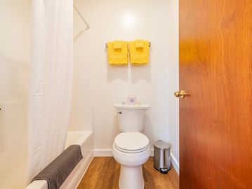 White bathroom with yellow towels