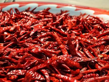 A plate full of dried red chili peppers.