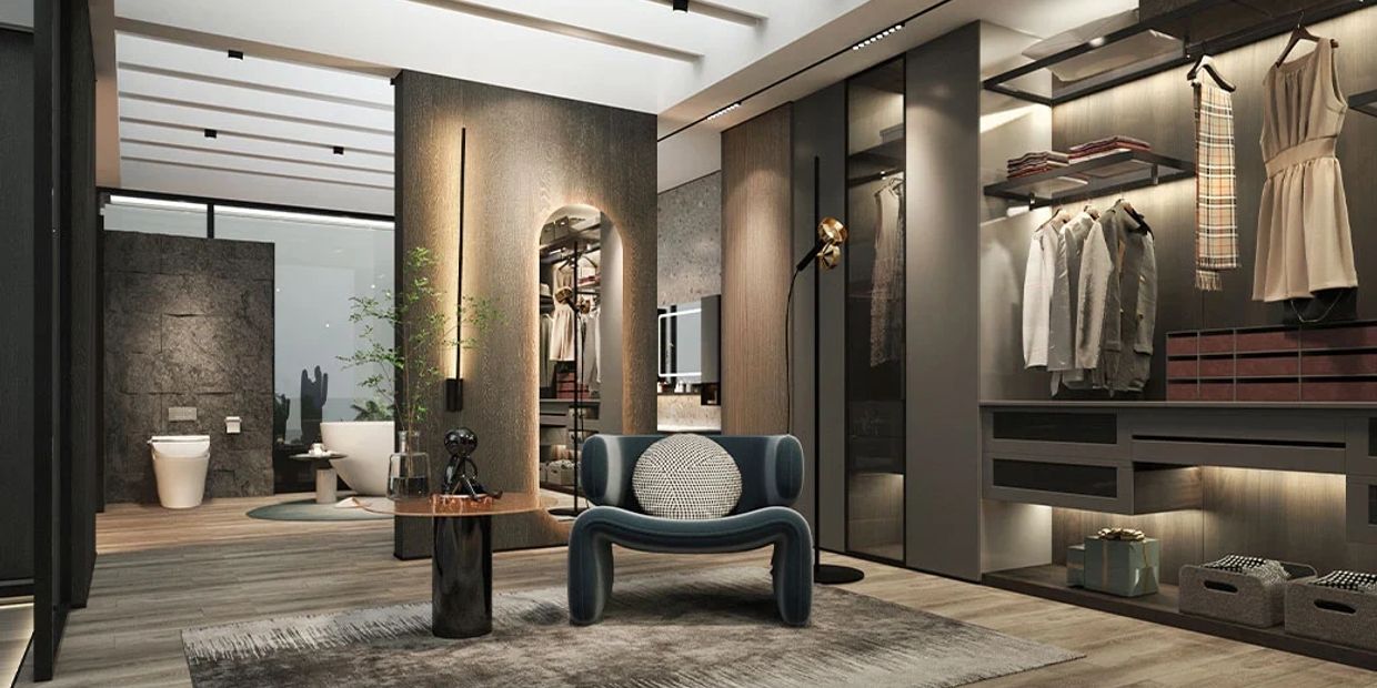 Modern walk-in closet with seating and open bathroom.
