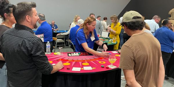 People playing blackjack at a casino table indoors.