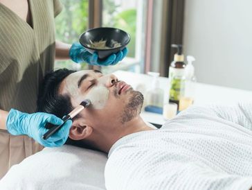 an Asian man getting a facial