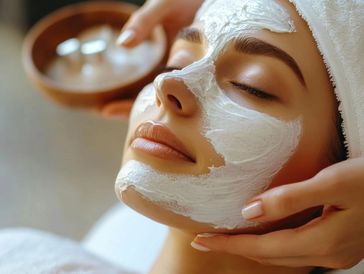 a young woman with white cream on her face for her facial
