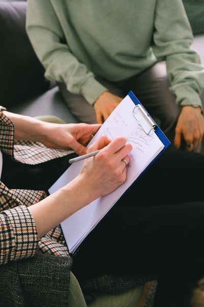 A person taking notes on a clipboard.