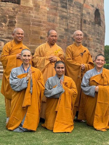 Myriam with Buddhist monks during a spiritual pilgrimage.