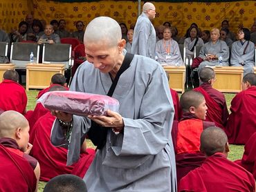 Myriam participating in a Buddhist ceremony and cultural healing tradition.