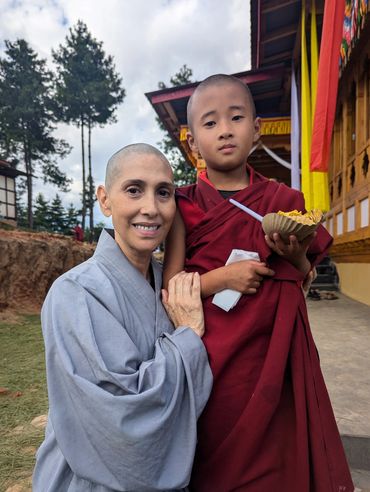 Myriam with a young Buddhist monk during her studies of spiritual traditions.