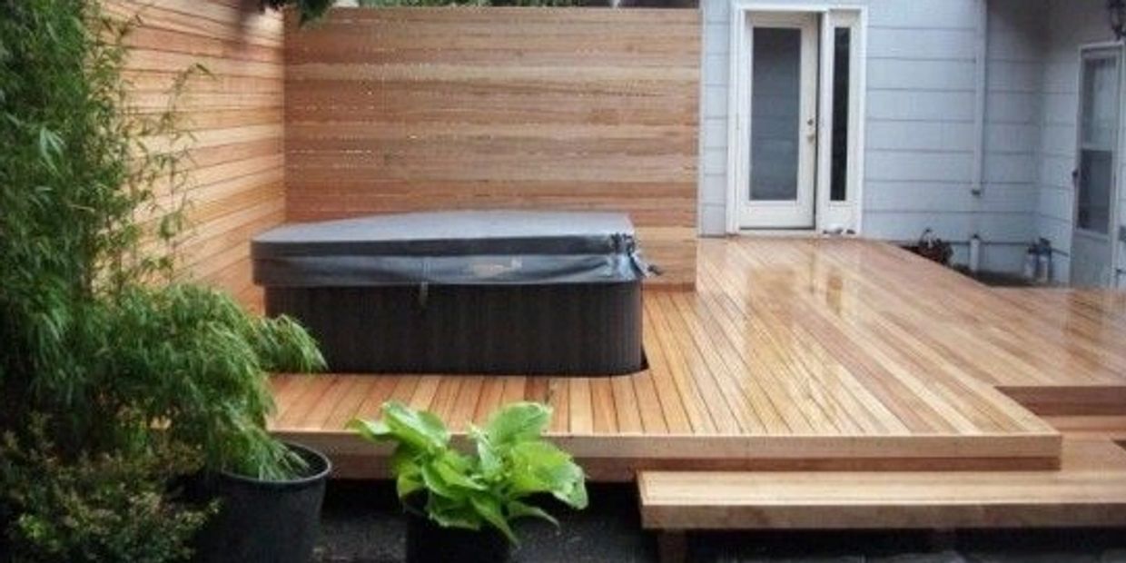 Floating deck and privacy wall for hot tub