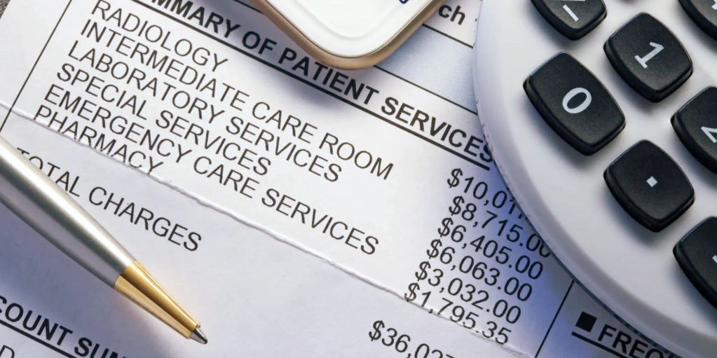 Medical bill summary with costs, pen, phone, and calculator.