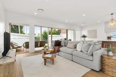 Bright modern living room with cozy gray sofa and natural wood accents.