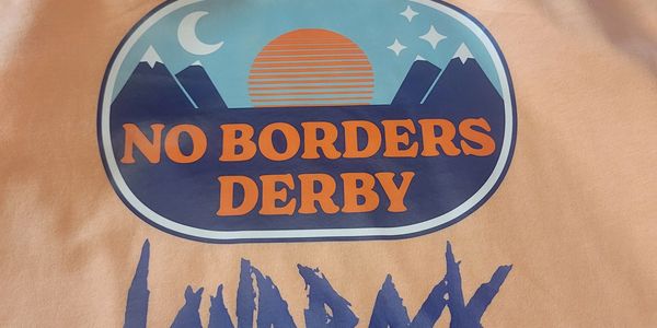 T-shirt with 'No Borders Derby' and mountain graphics design.