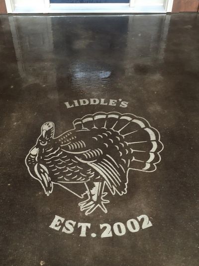 Polished concrete floor with a turkey and "Liddle's EST. 2002" design.