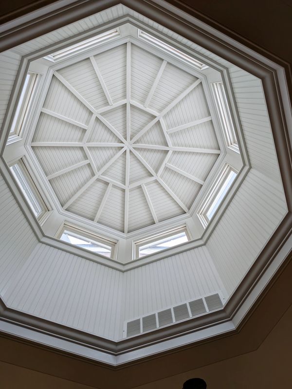 Intricate white octagonal skylight with window panels.