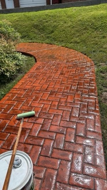 Herringbone stamped concrete completed in Johnson City, TN! Red color with a charcoal release