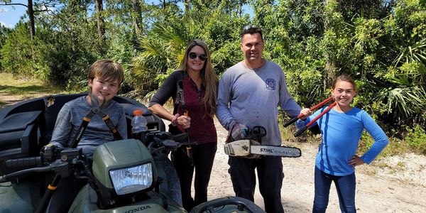 Family maintaining trail for Palm City Farms Association
