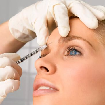 Doctor injecting botox into womans face