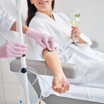 Nurse placing IV therapy in female patient
