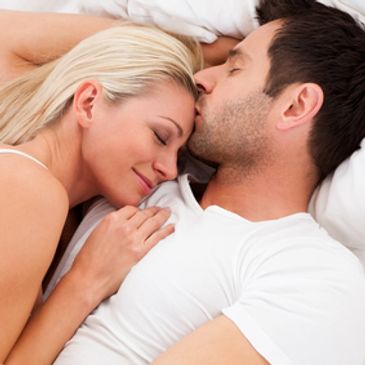 Couple laying in bed. Sexual health.