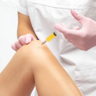 Doctor injecting knee with regenerative medicine