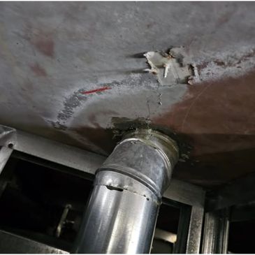 Metal pipe connected to a ceiling.