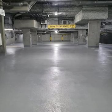 Empty underground parking garage with clearance sign.