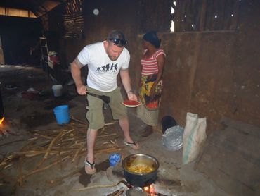 Vinnie at the kitchen assisting to make a meal at a Primary School during his kilimanjaro climb