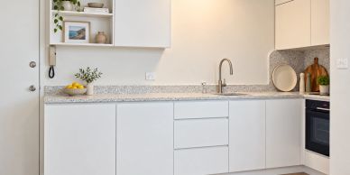 Stone bench and 2 pac finish modern kitchen with minimalist design.